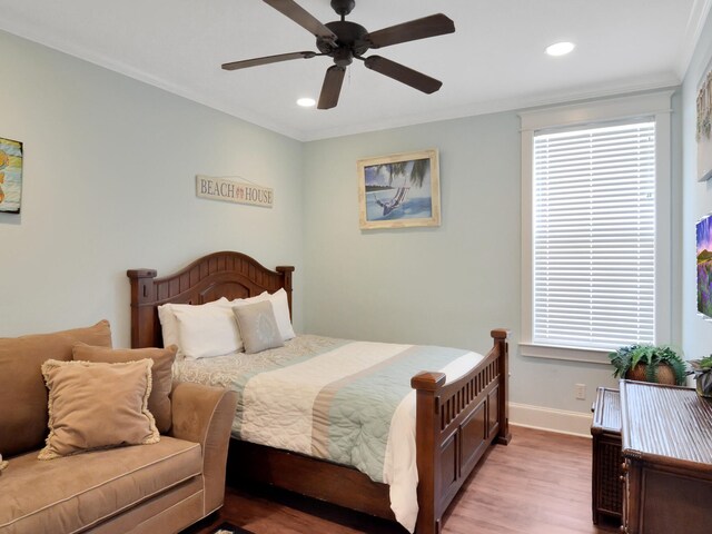 bedroom featuring ceiling fan, crown molding, and light wood-type flooring