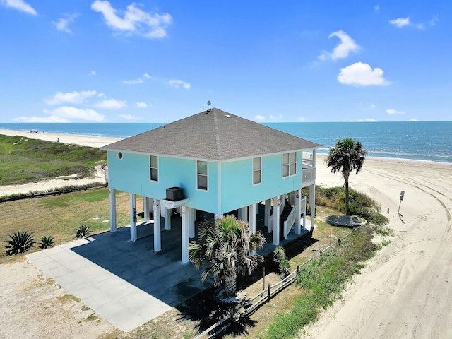 view of side of home featuring a water view and a carport