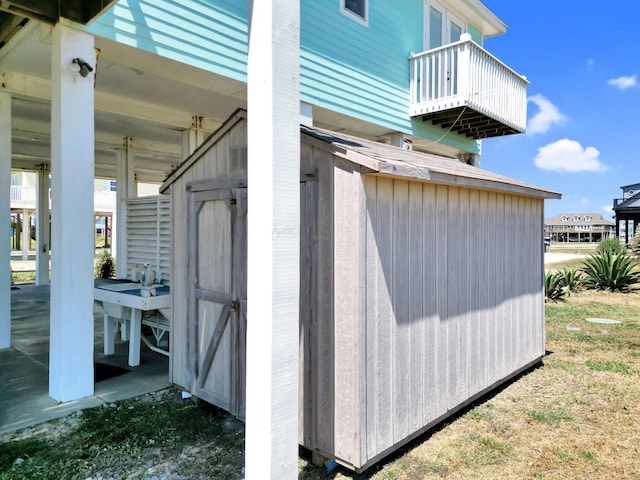 view of side of property featuring a storage unit