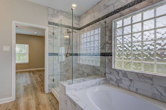 full bathroom featuring a garden tub, recessed lighting, a stall shower, wood finished floors, and baseboards