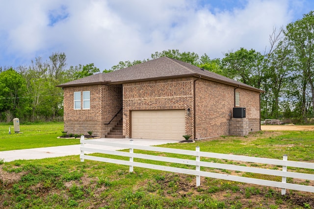 view of front of home with a garage and a front lawn