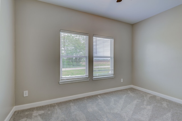 empty room featuring ceiling fan, carpet floors, and baseboards