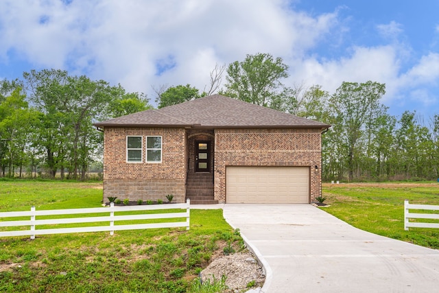 view of front of property featuring a garage and a front yard