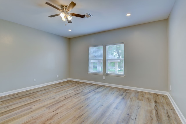 empty room featuring recessed lighting, visible vents, light wood-style flooring, a ceiling fan, and baseboards