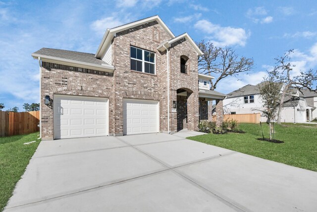 view of front of home with a garage and a front lawn