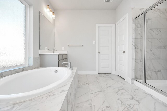 bathroom featuring shower with separate bathtub and vanity