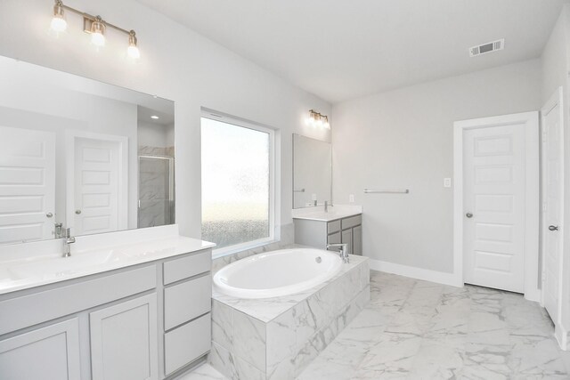 bathroom with vanity and separate shower and tub