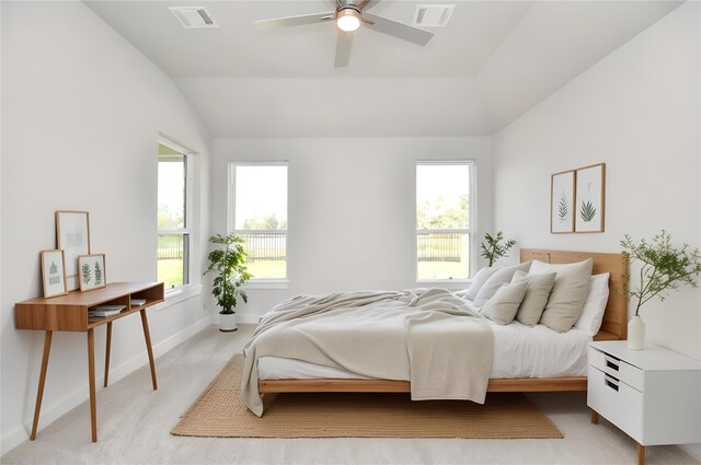 carpeted bedroom with ceiling fan and lofted ceiling