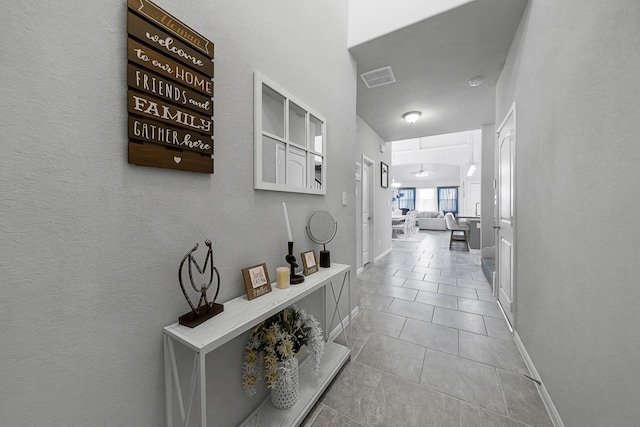 corridor featuring light tile patterned floors