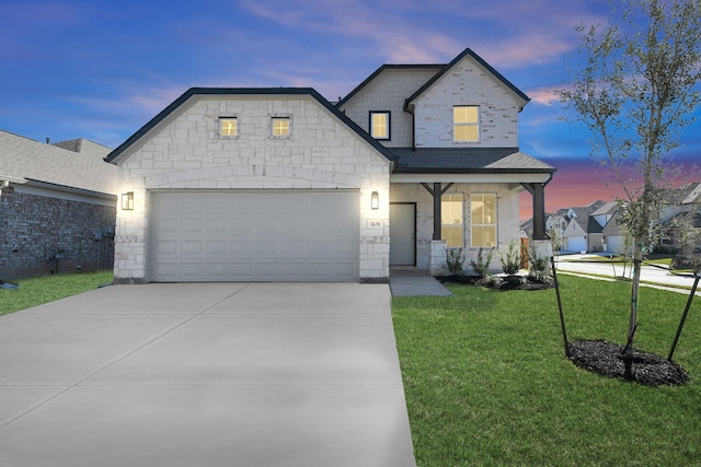 view of front of home with a lawn and a garage