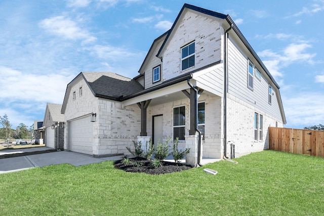 view of front of home with covered porch, a garage, and a front lawn