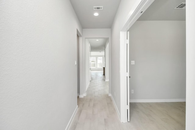 hall with light hardwood / wood-style flooring