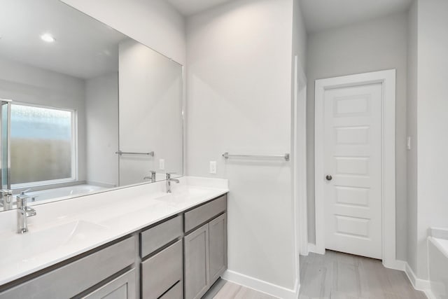 bathroom with a bathing tub and vanity