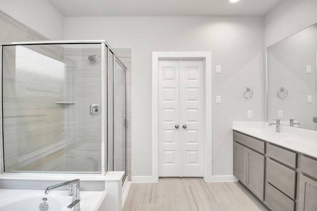 bathroom with shower with separate bathtub and vanity