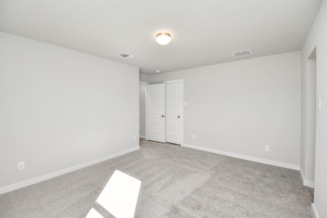 unfurnished room with light colored carpet