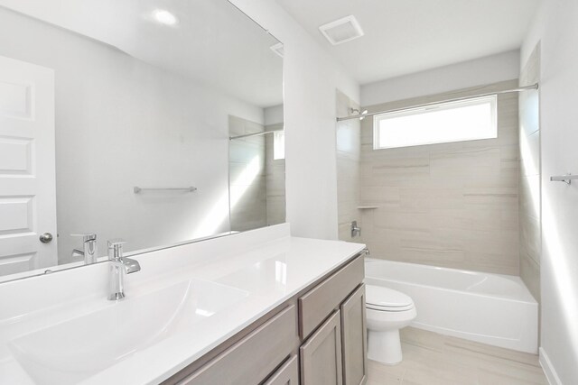 full bathroom with vanity, toilet, and tiled shower / bath