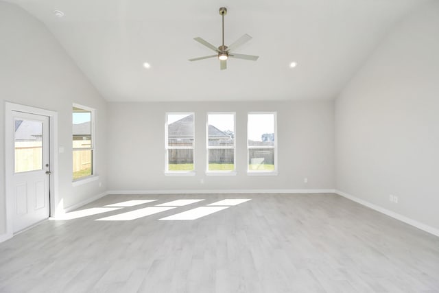 unfurnished living room with ceiling fan, light hardwood / wood-style floors, and vaulted ceiling