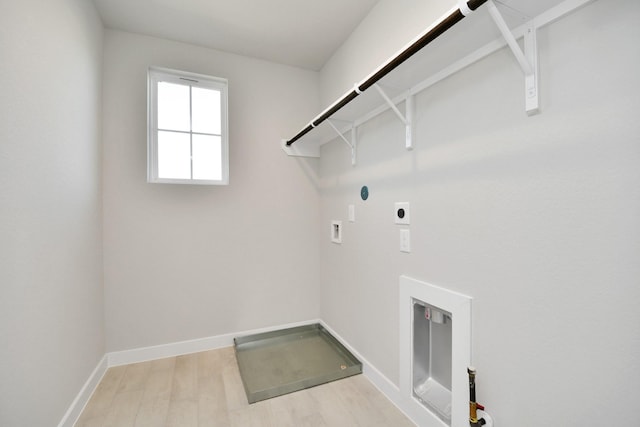 washroom featuring hookup for a washing machine, light wood-type flooring, and electric dryer hookup