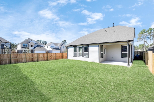 back of house with a lawn and a patio area