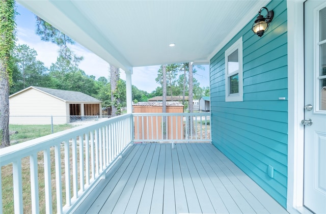 wooden terrace with an outbuilding