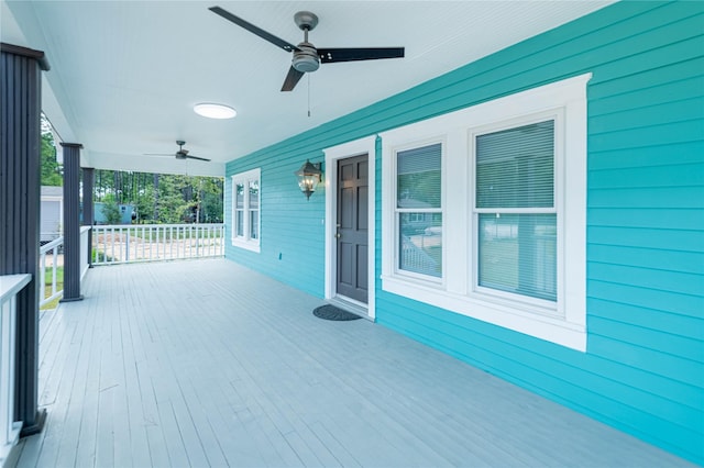 wooden deck featuring ceiling fan and a porch