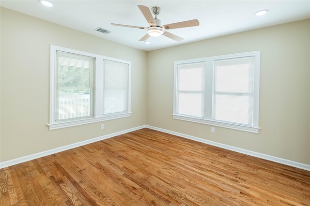 unfurnished room with recessed lighting, a ceiling fan, light wood-style floors, visible vents, and baseboards