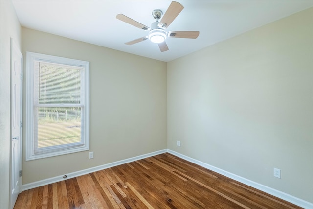 spare room with ceiling fan, baseboards, and wood finished floors