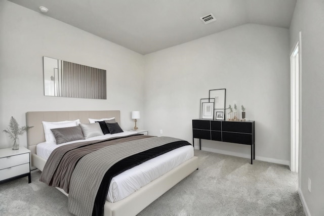 bedroom featuring lofted ceiling and light carpet