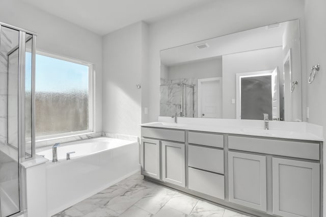 bathroom featuring vanity and separate shower and tub