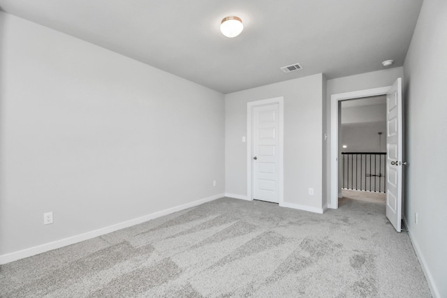 unfurnished bedroom featuring a closet and light colored carpet