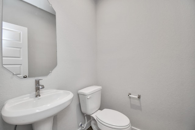 bathroom featuring toilet and sink