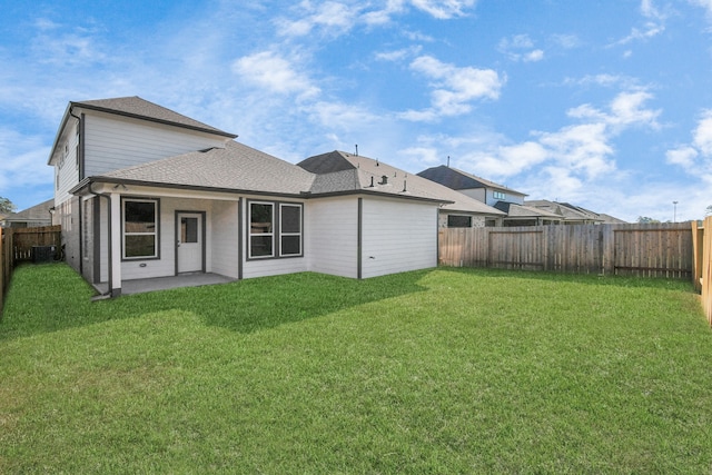 rear view of property featuring a patio area, central AC, and a lawn