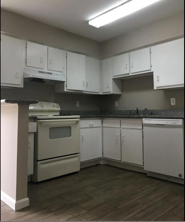 kitchen featuring white appliances, white cabinets, and dark hardwood / wood-style floors