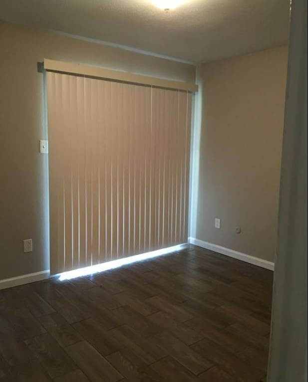 unfurnished room featuring dark hardwood / wood-style flooring