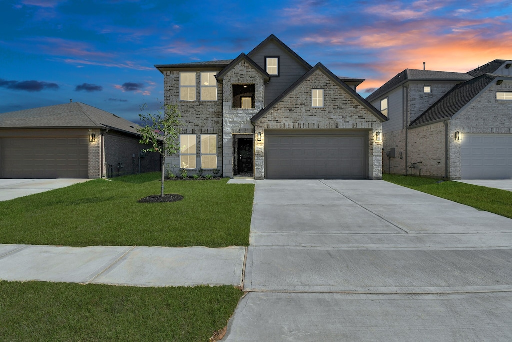 french country inspired facade with a yard