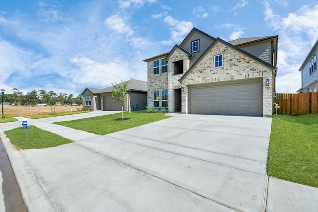 view of front of property with a front yard and a garage