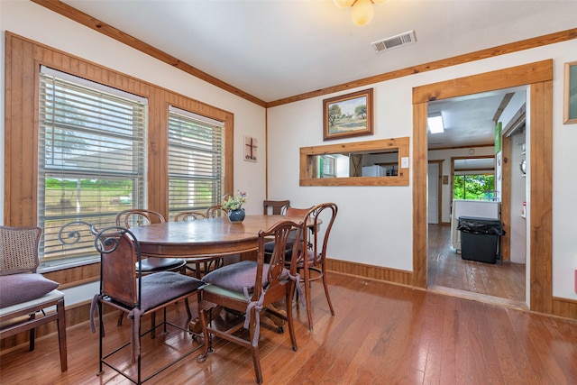 dining area featuring ornamental molding and hardwood / wood-style flooring