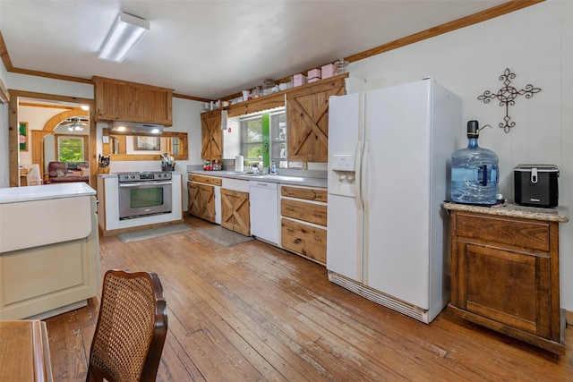 kitchen featuring ornamental molding, sink, light wood-type flooring, exhaust hood, and white appliances