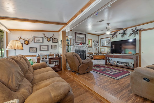 living room featuring beam ceiling, ceiling fan, track lighting, and wood-type flooring