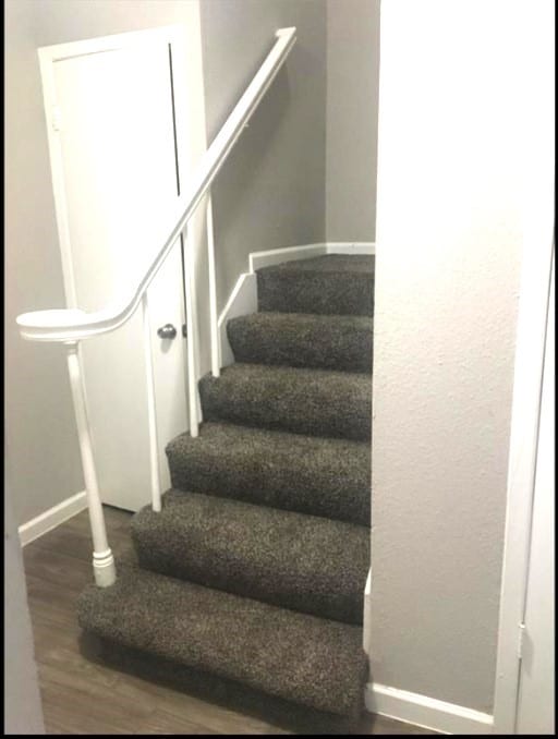 stairs featuring wood-type flooring