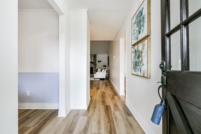 corridor with light hardwood / wood-style flooring