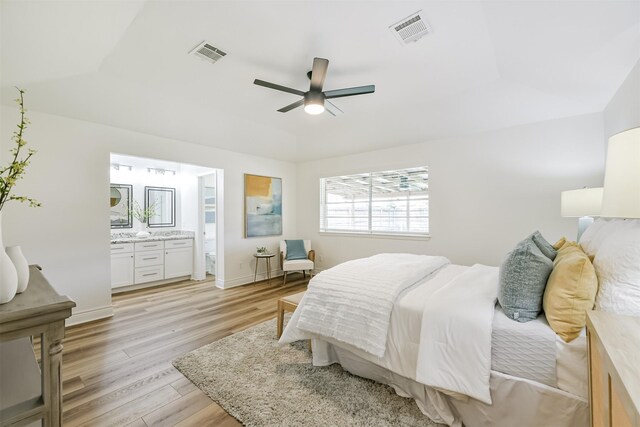 bedroom featuring ceiling fan, light wood-type flooring, and connected bathroom