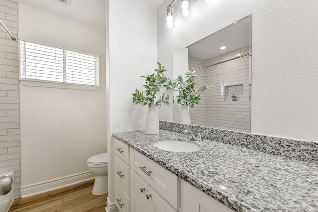 bathroom with hardwood / wood-style floors, toilet, and vanity