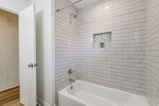 bathroom featuring tiled shower / bath combo and hardwood / wood-style floors