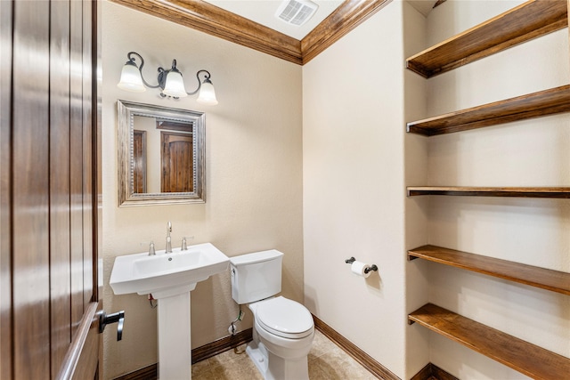 half bathroom with toilet, visible vents, baseboards, ornamental molding, and tile patterned floors