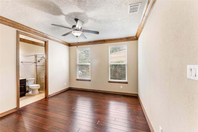 unfurnished bedroom featuring dark wood-style floors, visible vents, crown molding, and a textured ceiling