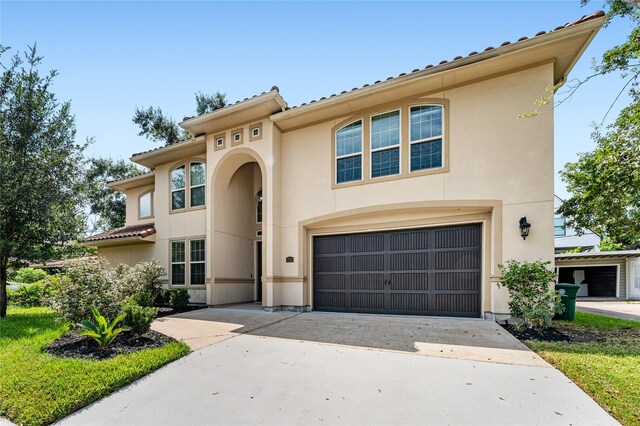 mediterranean / spanish house featuring a garage