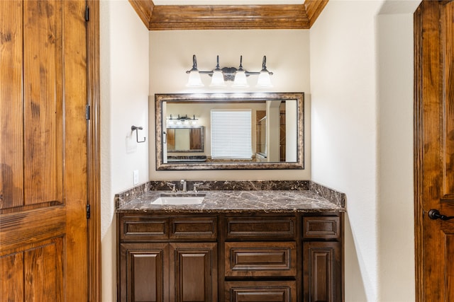 bathroom with ornamental molding and vanity