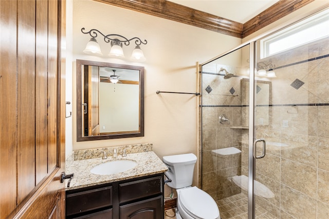 bathroom with ornamental molding, toilet, a shower stall, and vanity