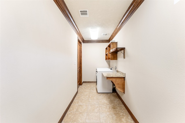 washroom with a textured ceiling, laundry area, visible vents, baseboards, and crown molding